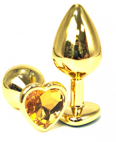 Золотистая анальная пробка с оранжевым кристаллом-сердцем - 7 см. Золотистая анальная пробка с оранжевым кристаллом-сердцем - 7 см.